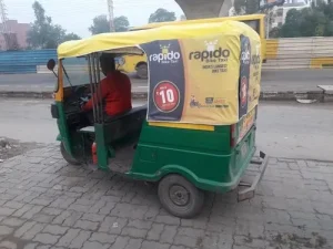 A fleet of auto rickshaws in Surat featuring vibrant advertisements, demonstrating the impact of mobile transit media in reaching large urban audiences.