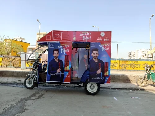 A branded auto rickshaw displaying vibrant ad panels on busy Thane roads, showcasing effective local advertising reach.