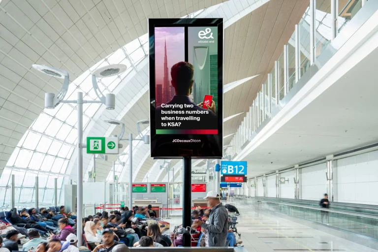 E& airport campaign, JCDecaux digital OOH, DXB targeted ads, UAE to Saudi roaming, smart airport advertising