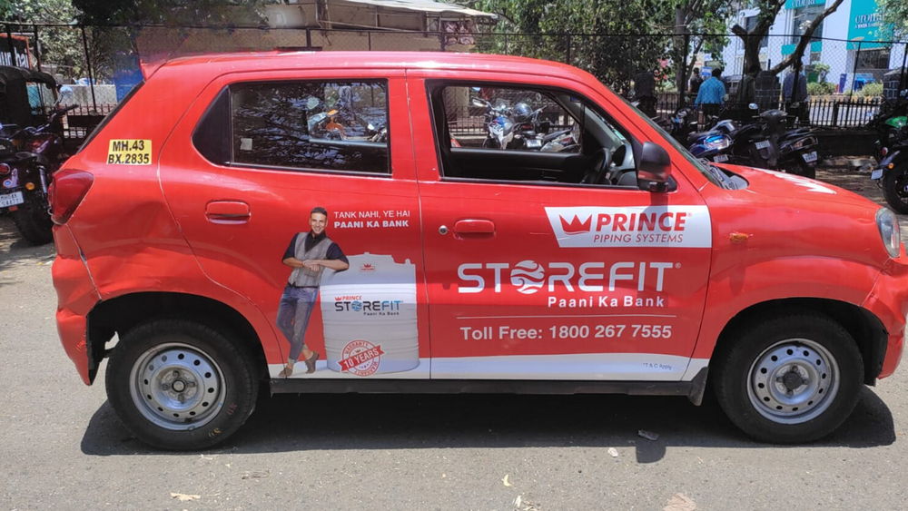 Sharda University’s car wrap ad promotes global learning and diversity through creative OOH transit advertising.