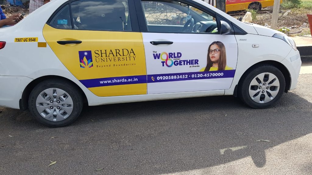 Sharda University’s car wrap ad promotes global learning and diversity through creative OOH transit advertising.