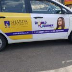 Sharda University’s car wrap ad promotes global learning and diversity through creative OOH transit advertising.