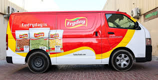 Taxi with digital LED top display showing brand advertisement moving through busy Indian city traffic.