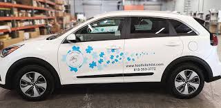 Taxi with LED advertising screen driving through Mumbai city traffic displaying a brand campaign.